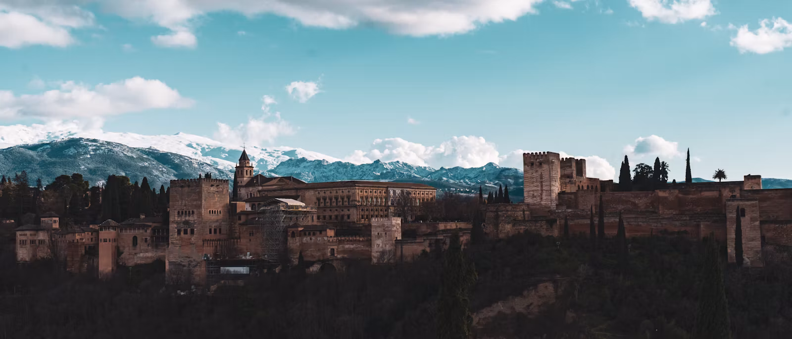 The Alhambra on its hill with the snow on the Sierra Nevada behind